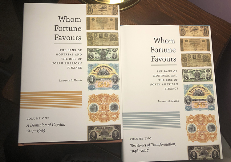 Whom Fortune Favours books, volume 1 & 2 sitting on a table